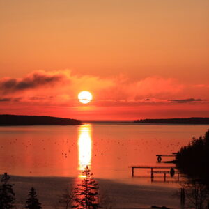 Orange sunrise over open water.